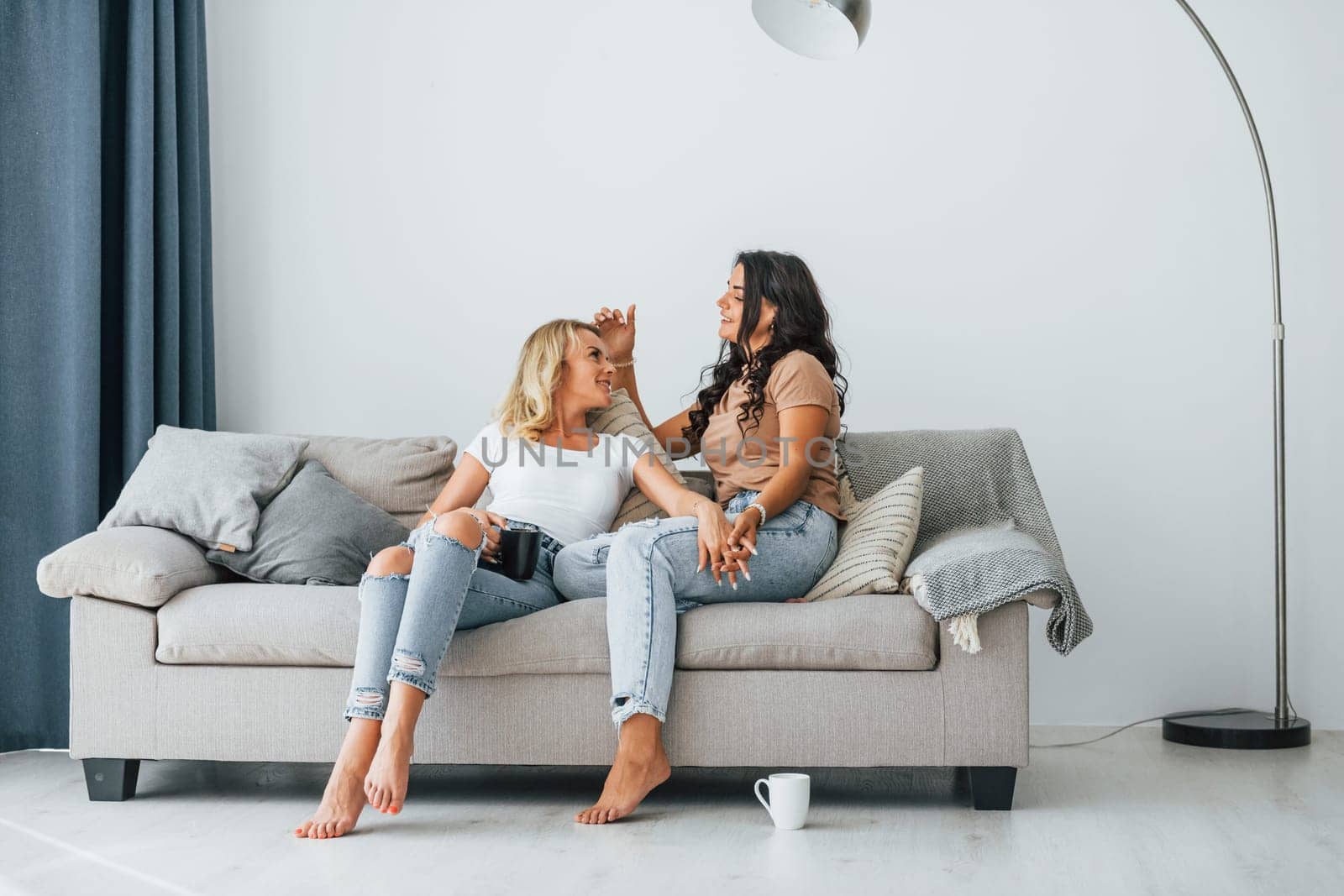 Having conversation. Two women is together at home.