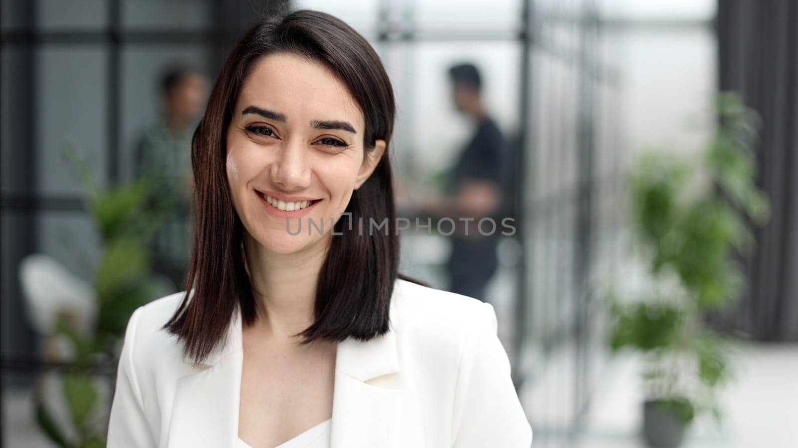 Beautiful young lady in white jacket smiling at camera by Prosto