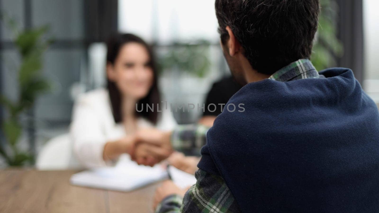 business people sitting at the table talking back view