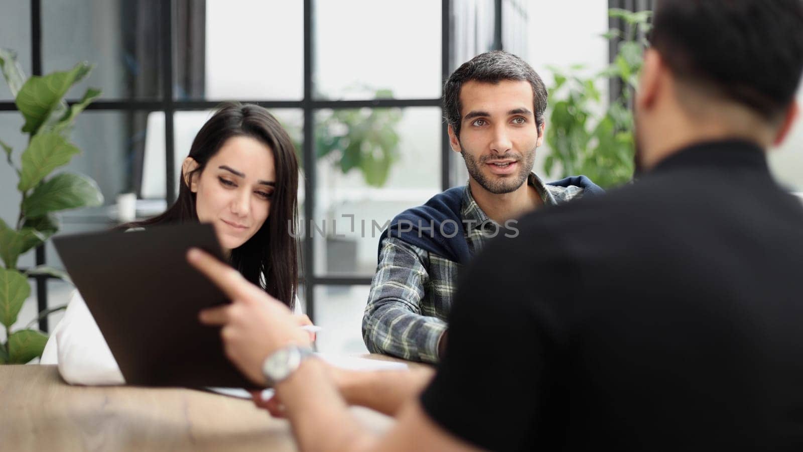 shirt shows a report to colleagues at work in the office