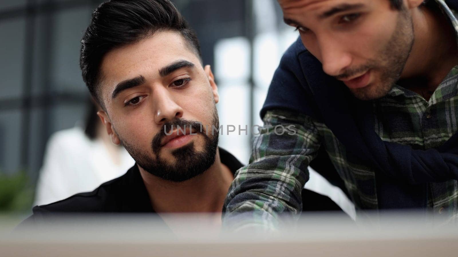 Businessman working on a laptop computer in the office by Prosto