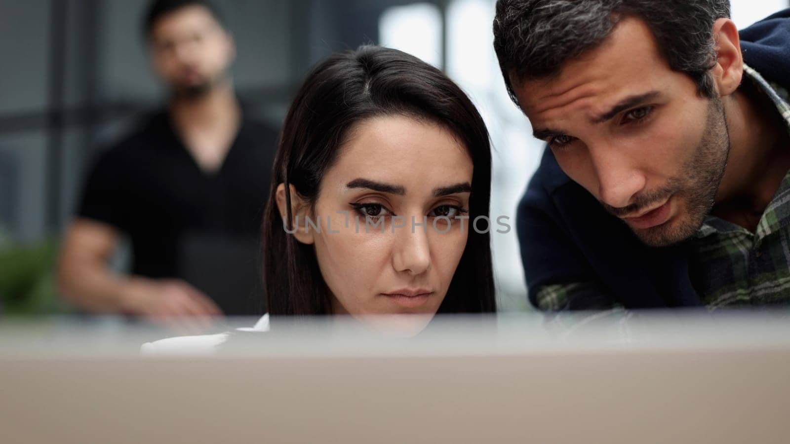 businesswoman talking to her colleague about business plan in conference while sitting behind her laptop at office.