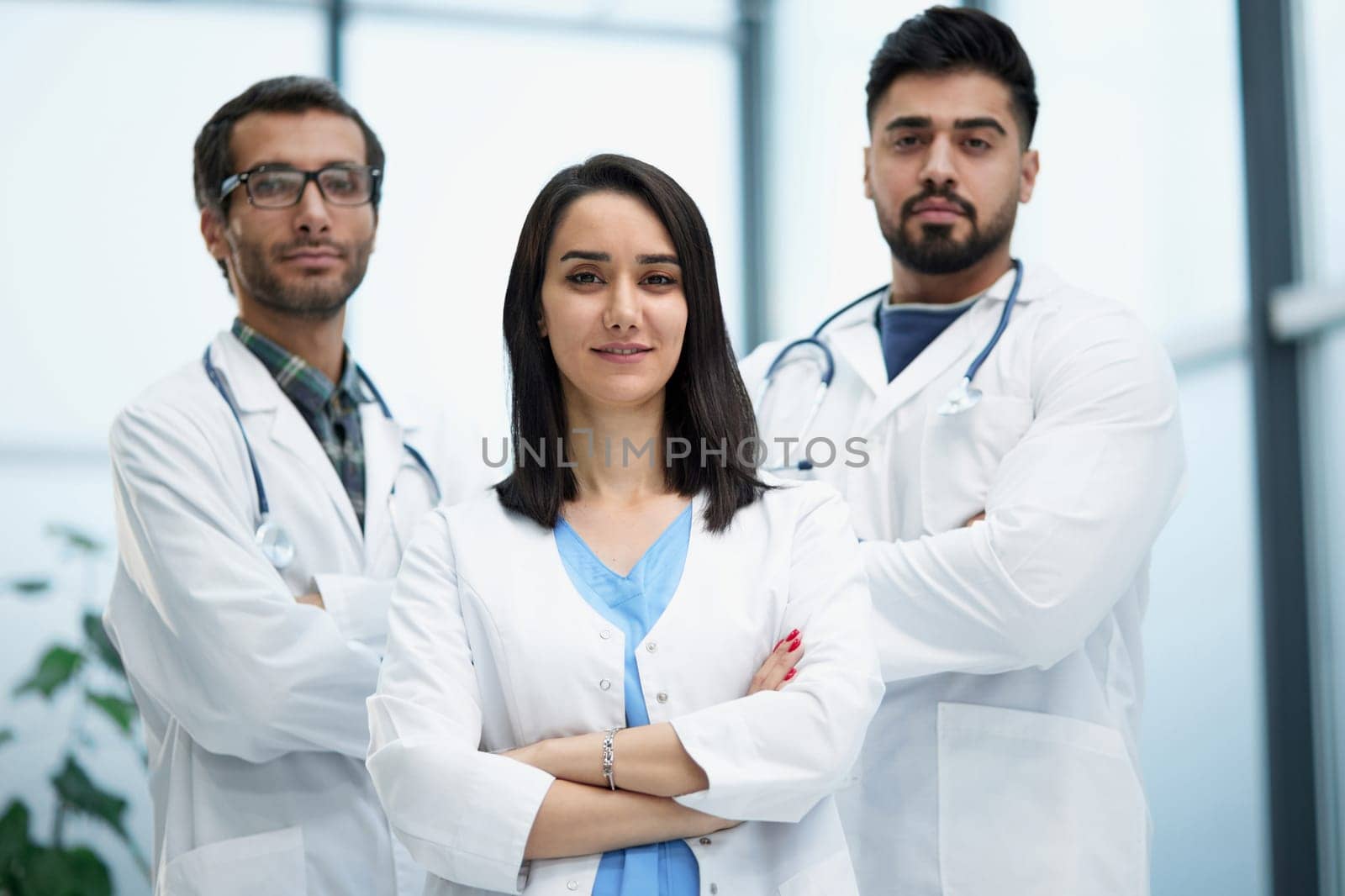 Portrait of three confident doctors in the hospital corridor