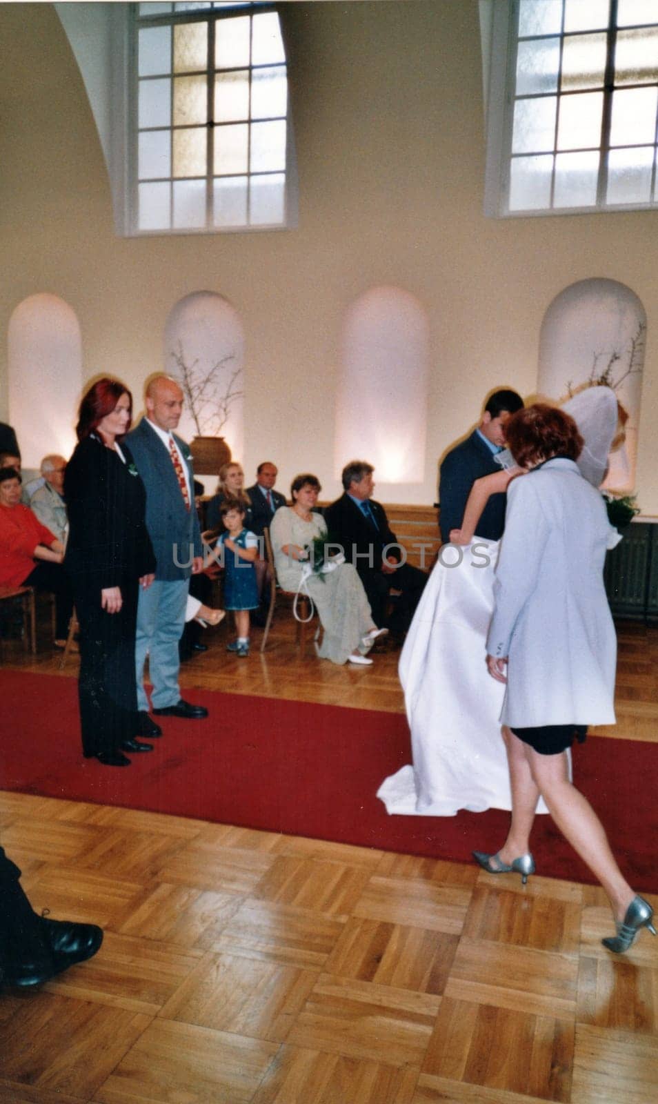 THE CZECHOSLOVAK REPUBLIC - CIRCA 1990s: Retro photo shows newlyweds and wedding guests during wedding ceremony. Vintage color photography Circa 1990.