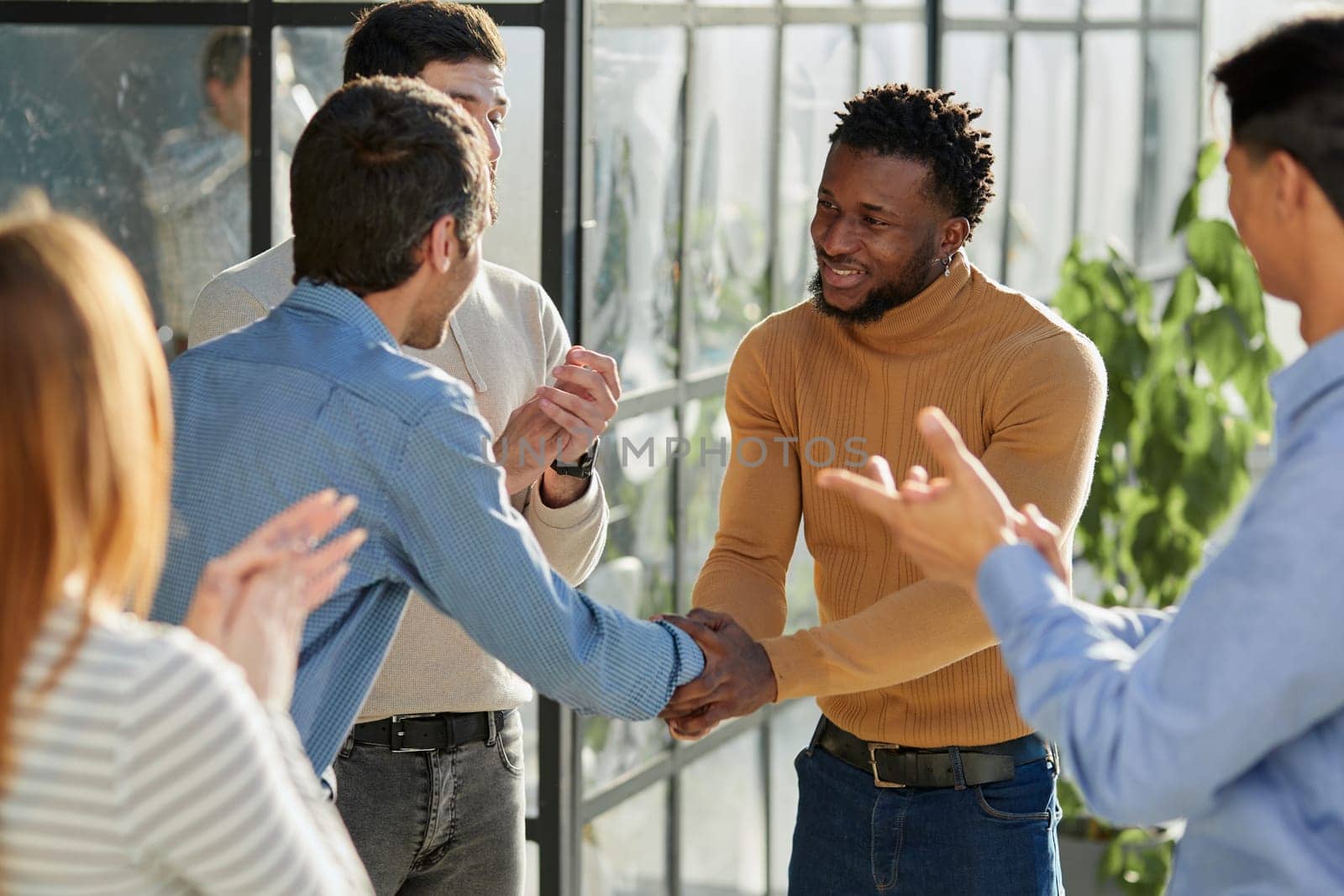 Shot of a happy businessman welcoming his new colleague to the team during a meeting in the boardroom.