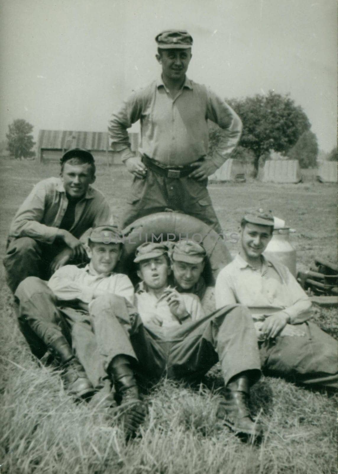 Retro photo shows young men - soldiers pose outdoors. Vintage photography. Circa 1970. by roman_nerud