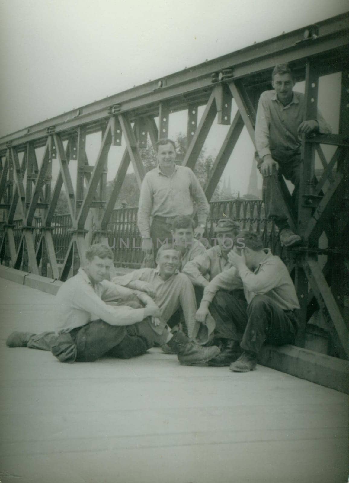 Retro photo shows combat engineers - sappers pose on the bridge construction. Vintage photography. Circa 1970. by roman_nerud