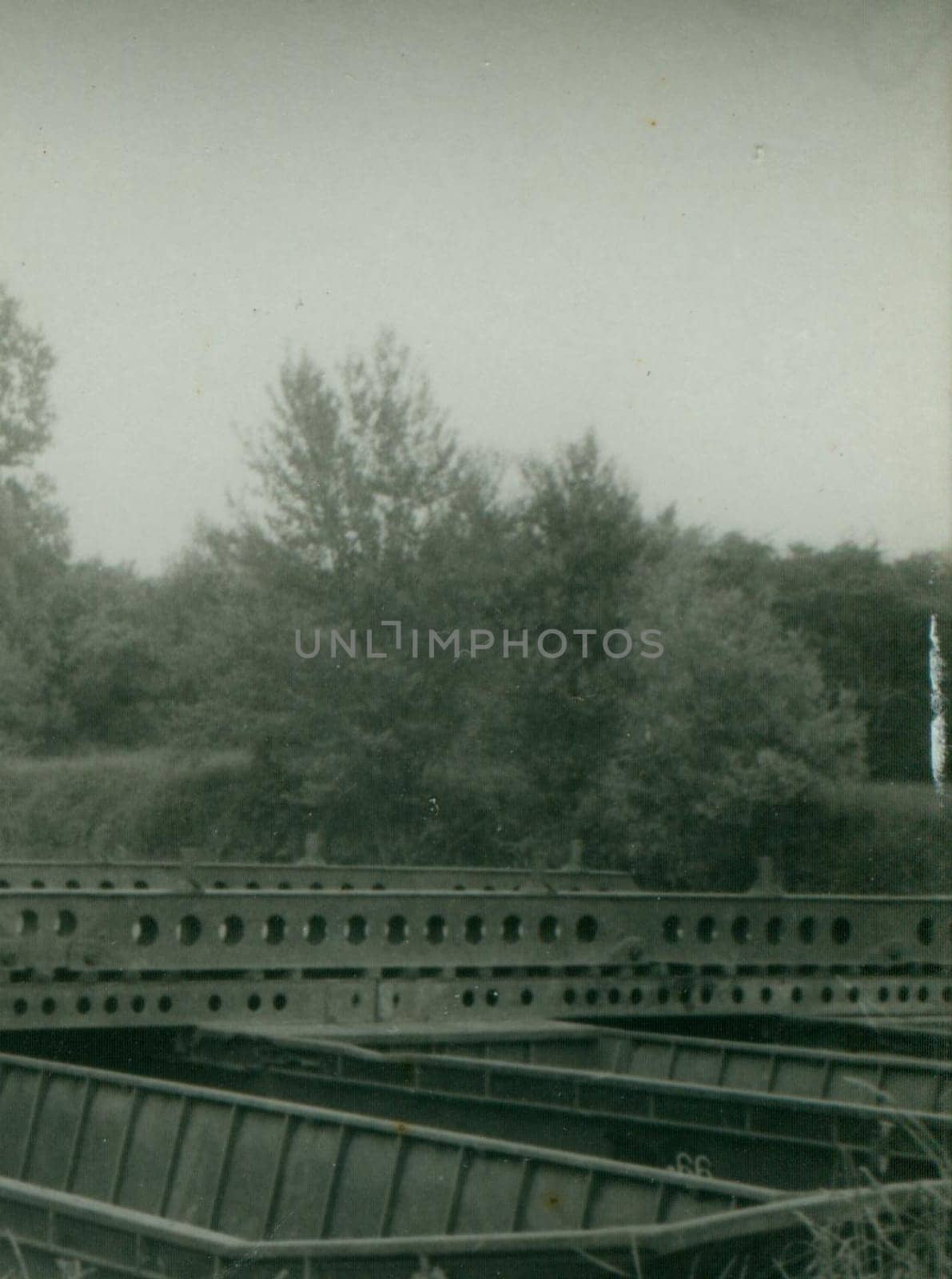 Retro photo shows pieces of the bridge construction - pontoon bridge. Vintage photography. Circa 1970. by roman_nerud