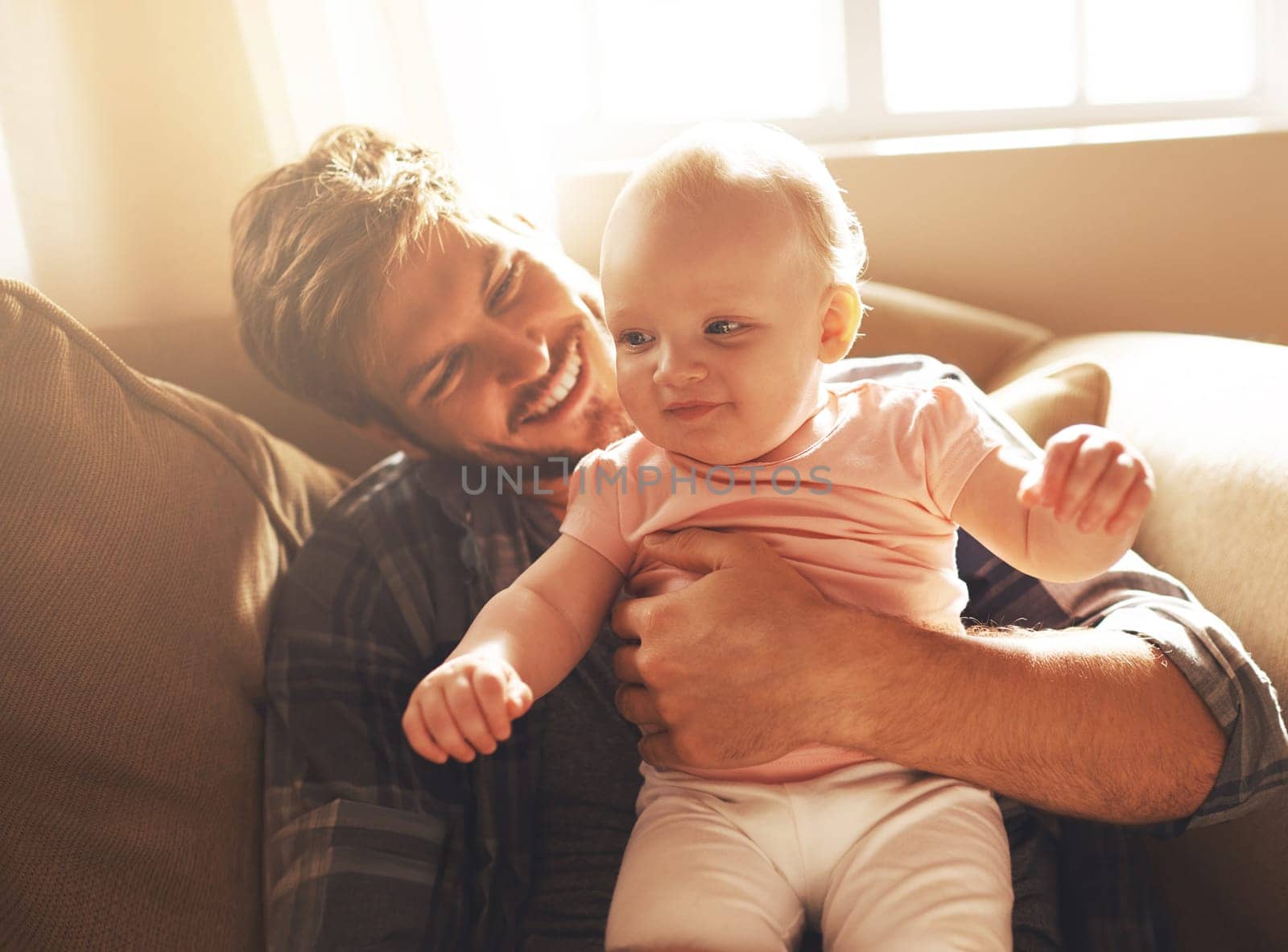 Dont you ever grow up. a young father and his baby daughter in the living room