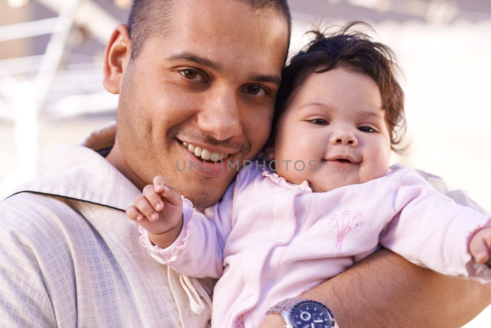 Say cheese for daddy. a father cradling his little baby girl