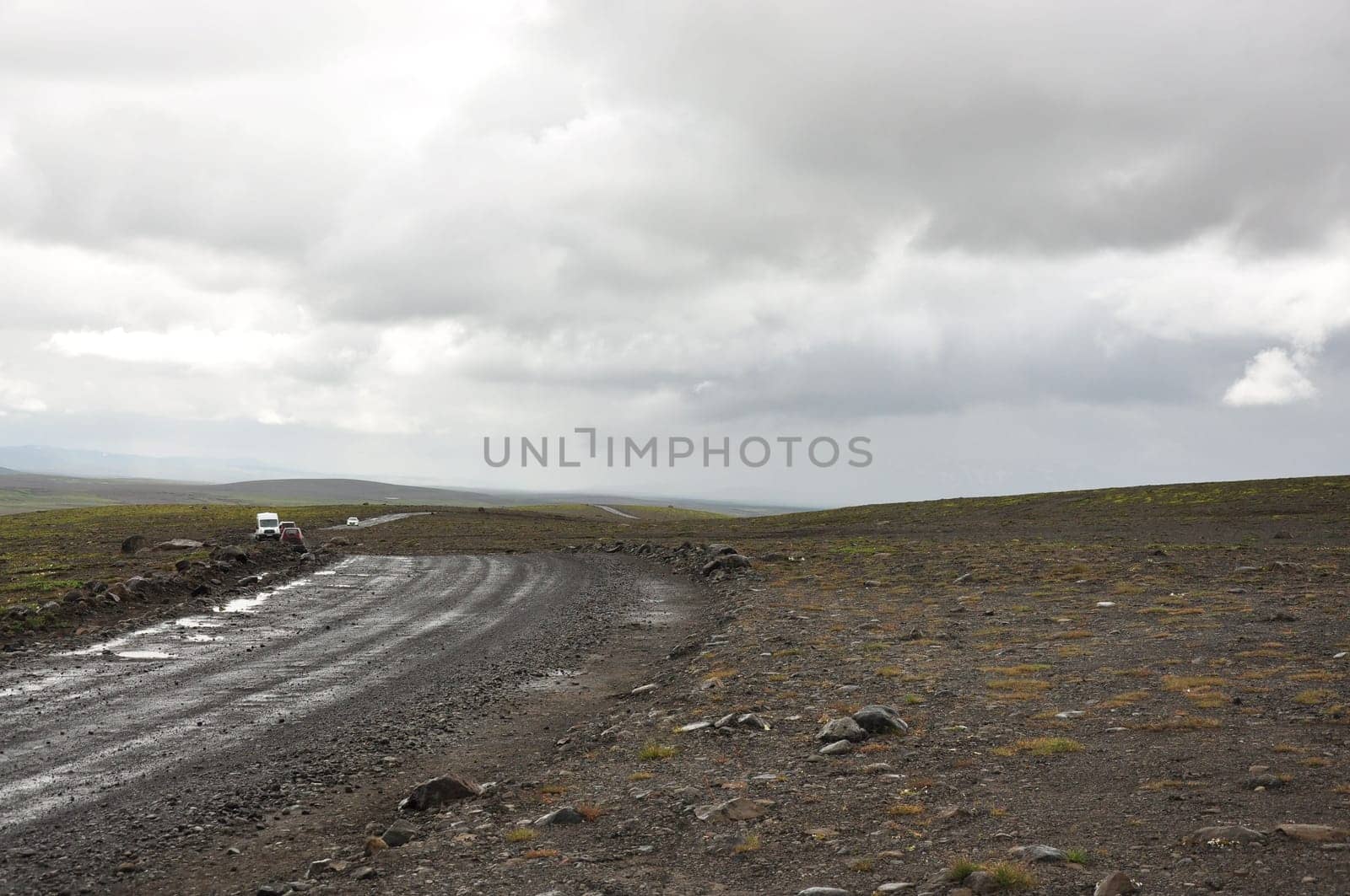 Scenic view of vehicles on gravel road in Iceland's inland