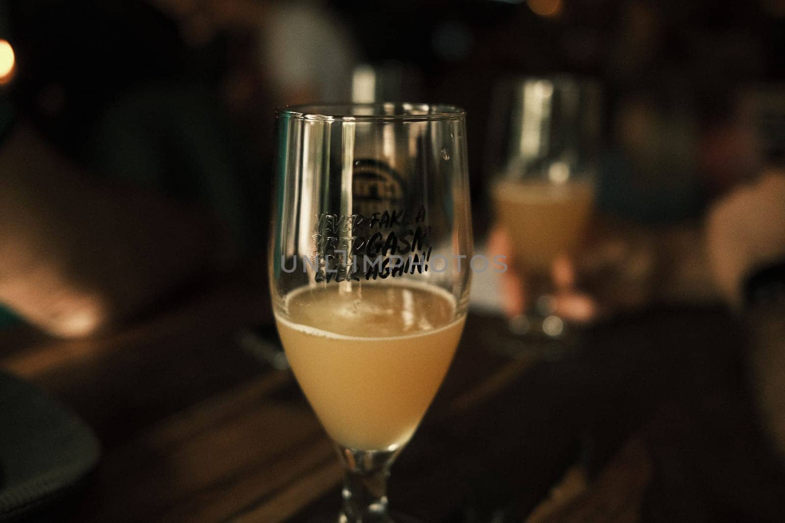 Close-up view of a craft beer in a port glass on the bar counter