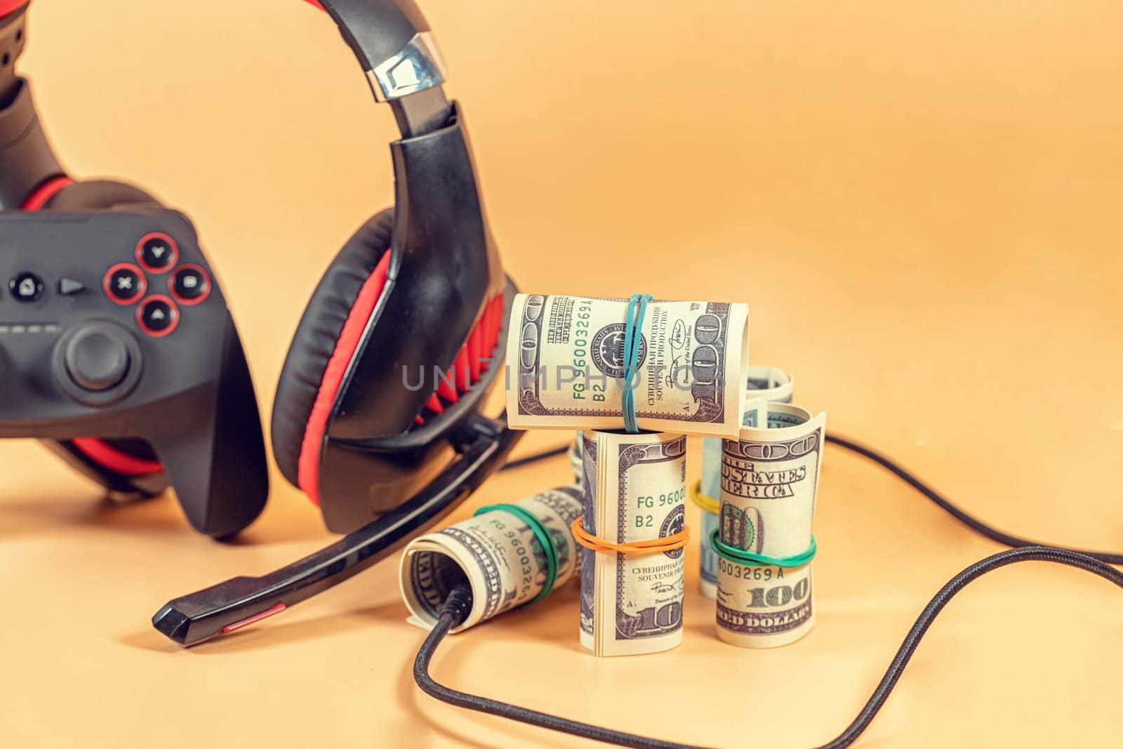 Game kit in red and black: wireless gamepad and audio headset. Such things help a gamer to earn money