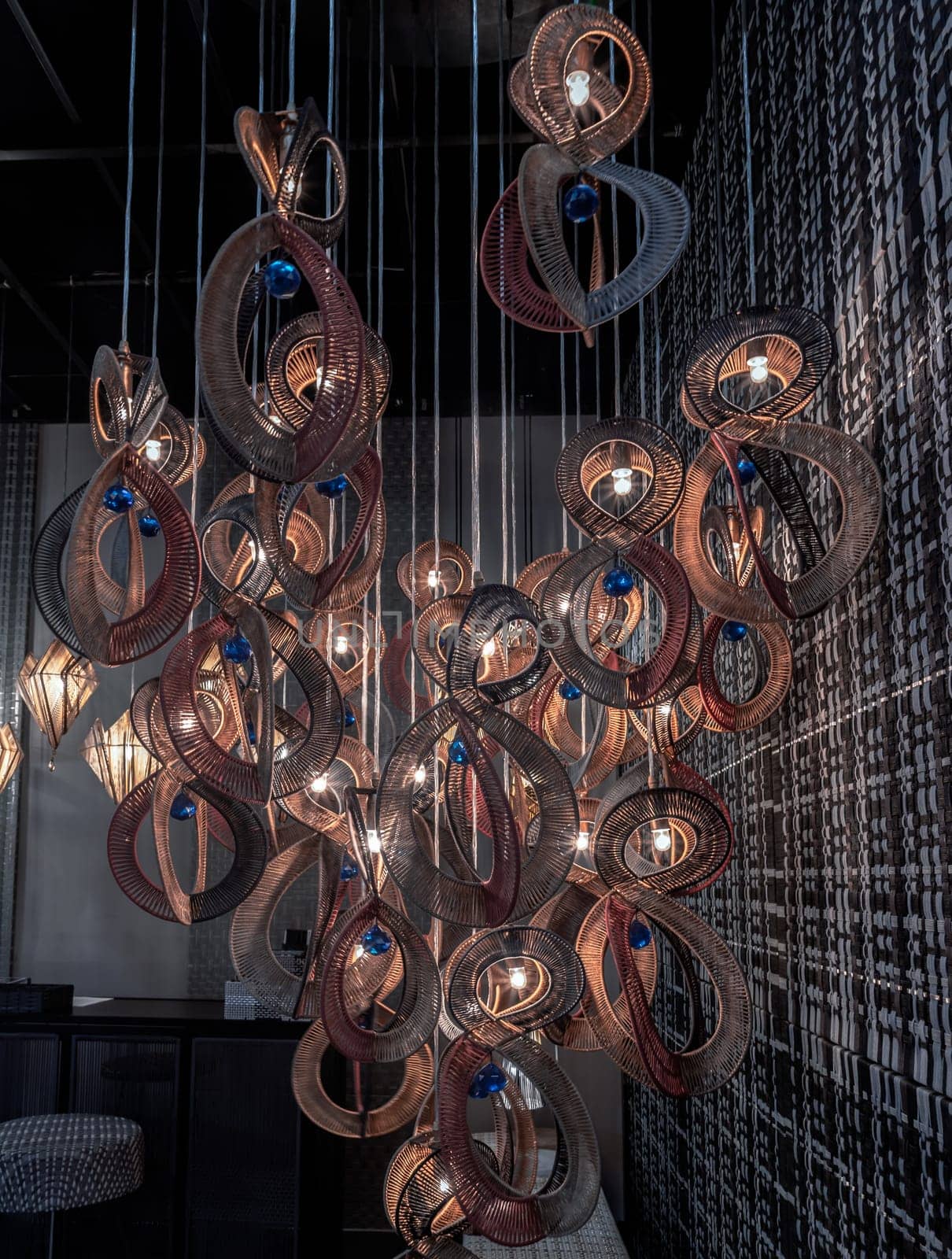 Bangkok,Thai - Apr 29, 2022 : Softly shining hanged lamps with Braided Colorful Ropes, which means in Chinese Lucky Number Eight with dark background. Beautiful decor for the interior, 8 infinity unlimited lucky signs concept, No focus, specifically.