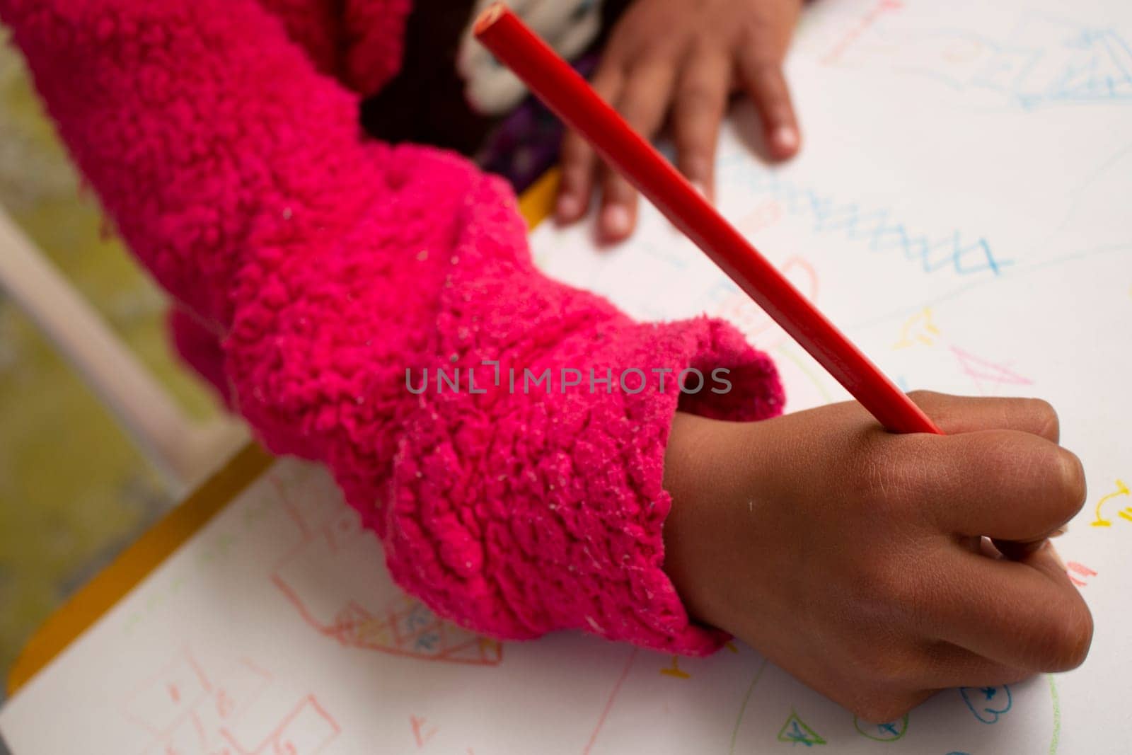 close-up of a girl's arm and hand with a pencil. High quality photo