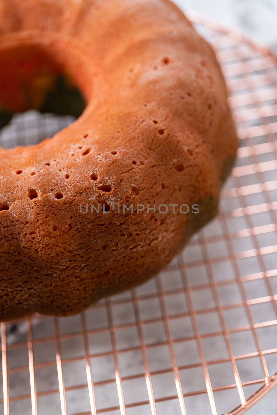 Cooling freshly baked bundt cake on a round cooling rack.