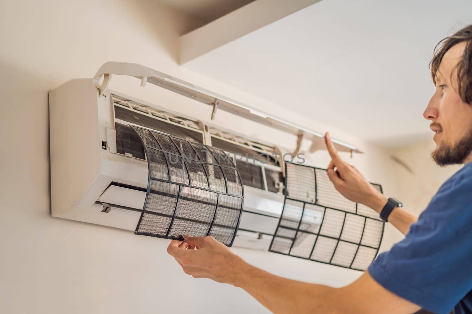 technician service removing air filter of the air conditioner for cleaning.