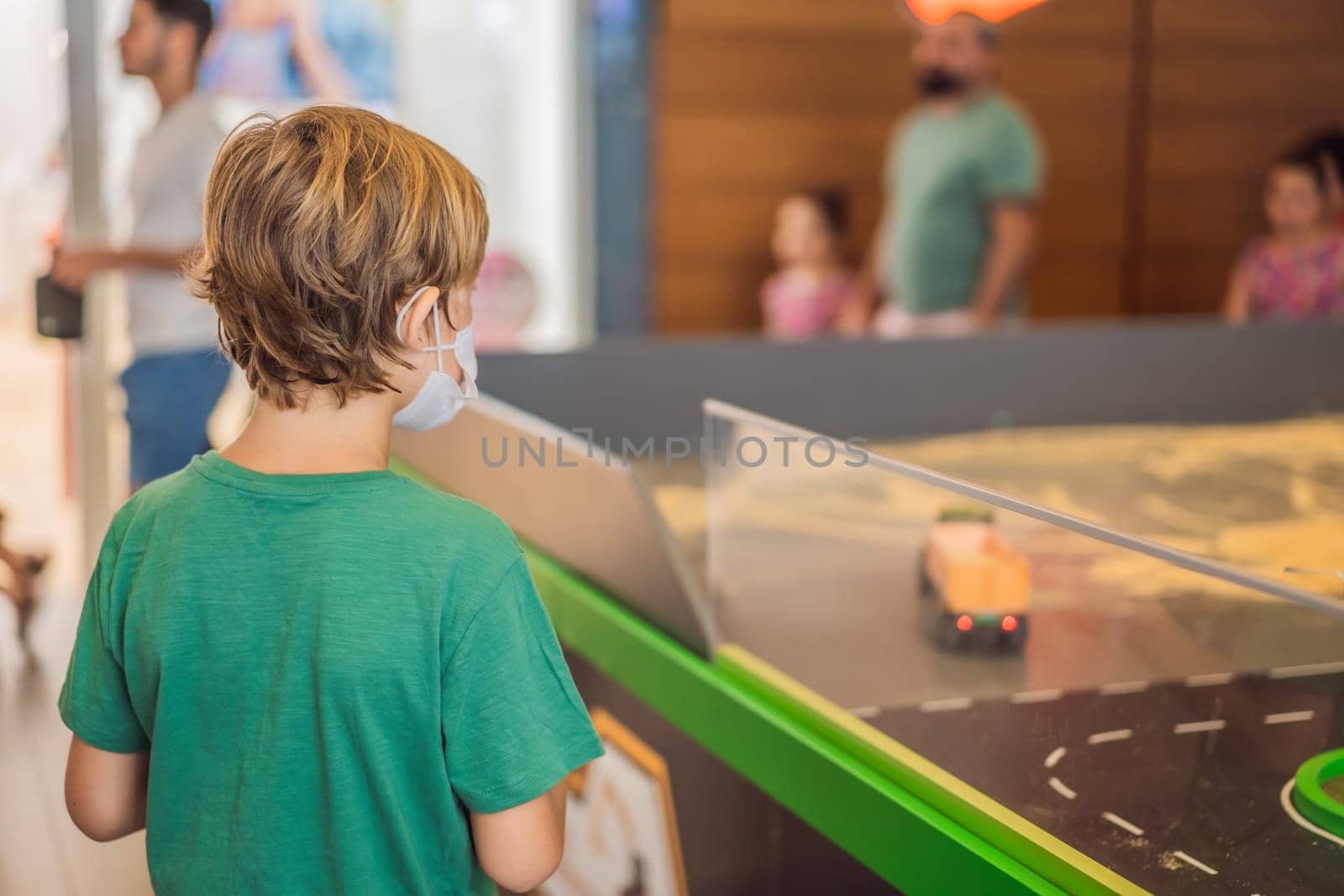 Adorable cute little child playing with toy on remote control, in the mall. Happy kid boy having fun. Leisure, lifestyle for kids concept.