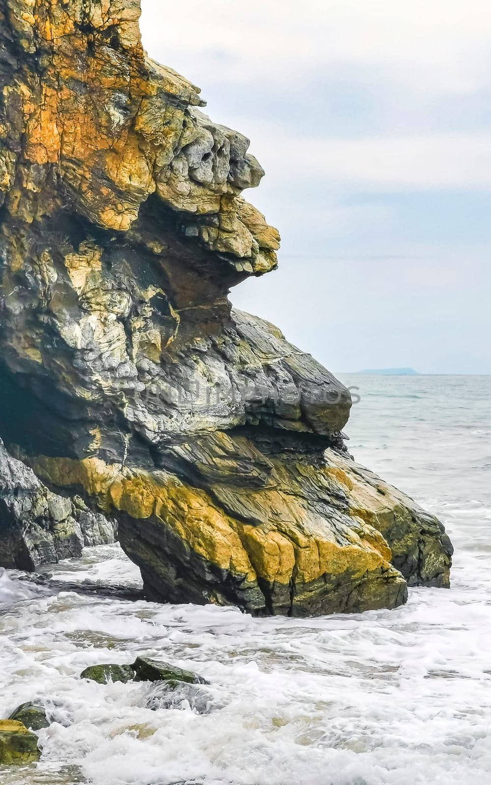 Extremely beautiful huge big surfer waves rocks cliffs stones and boulders on the beach in Zicatela Puerto Escondido Oaxaca Mexico.