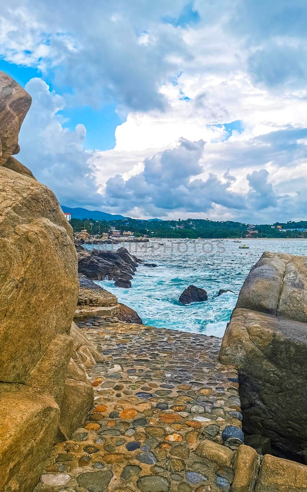 Extremely beautiful huge big surfer waves rocks cliffs stones and boulders on the beach in Zicatela Puerto Escondido Oaxaca Mexico.