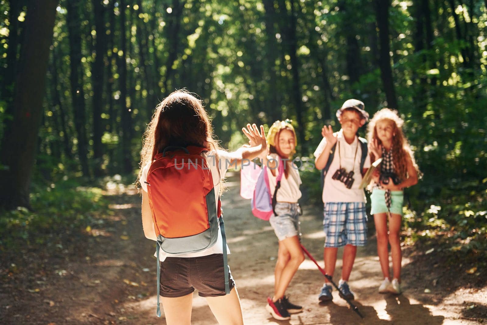 Ready for adventure. Kids strolling in the forest with travel equipment by Standret