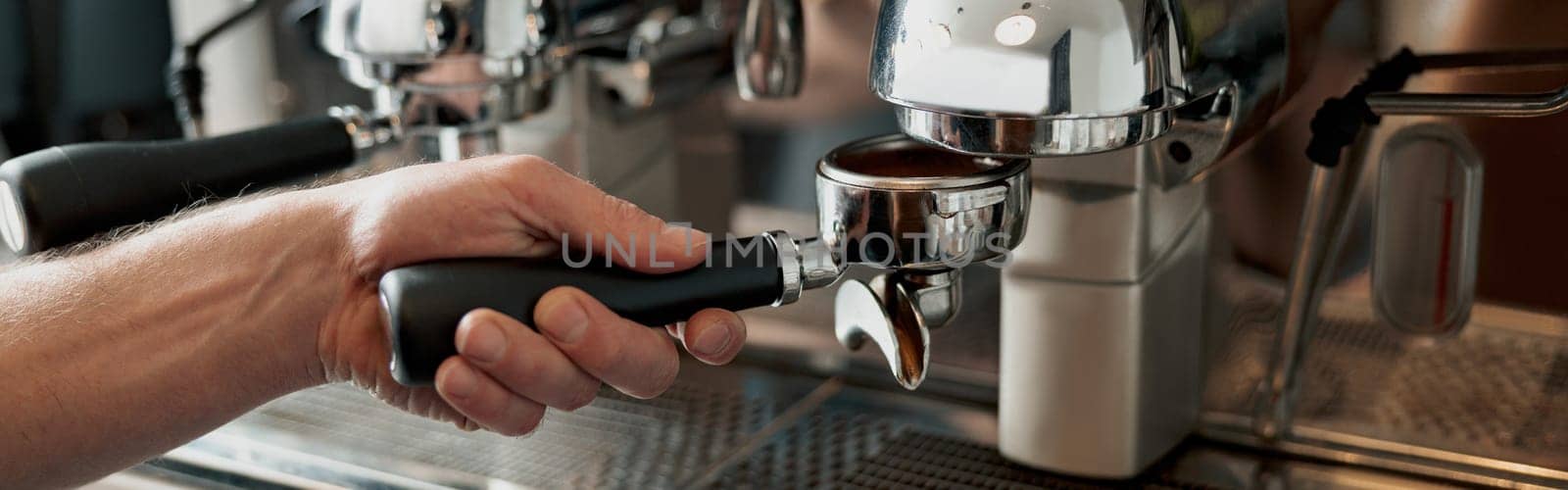 Process of pouring ground coffee into the filter from the coffee grinder