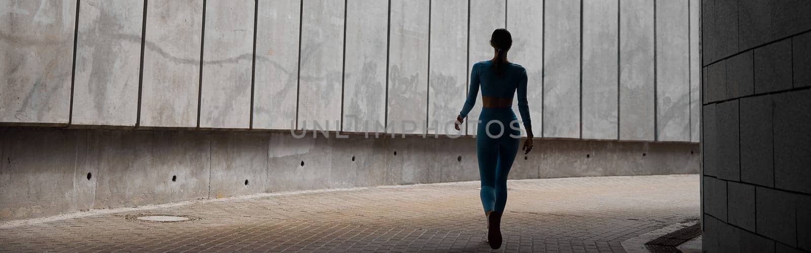 Beautiful fit young woman jogger is running outdoors