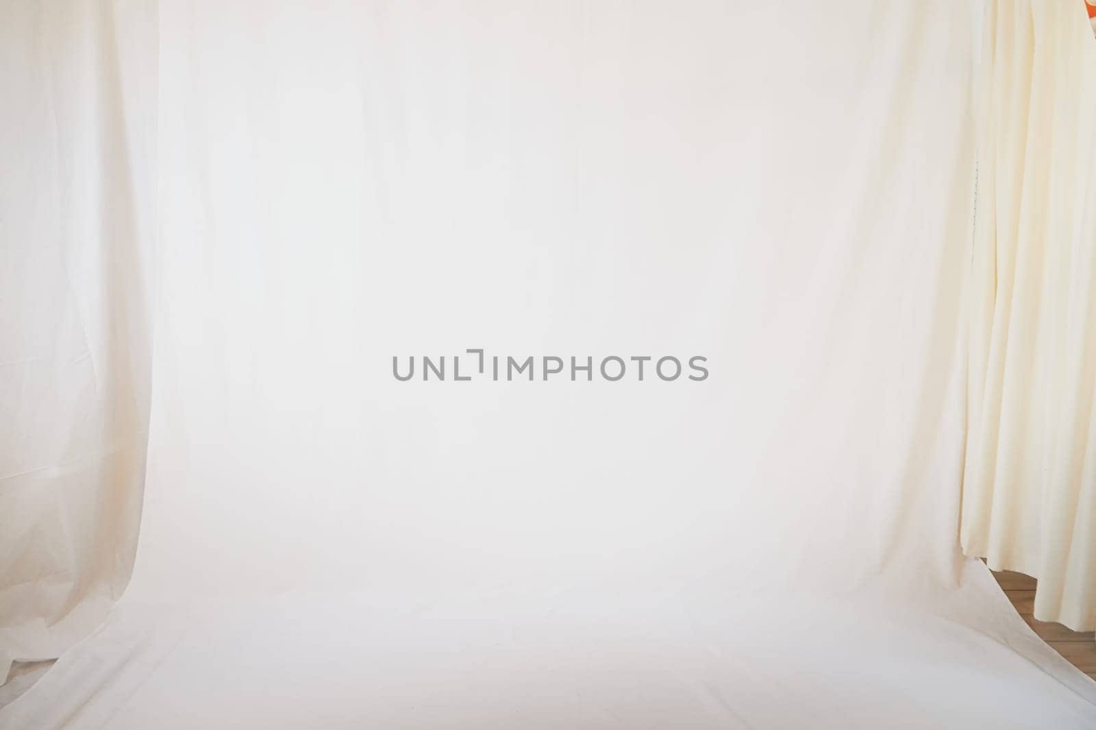 White fabric background and light curtains. Location, frame for shooting in a photo studio. Theater stage for backstage performances by keleny