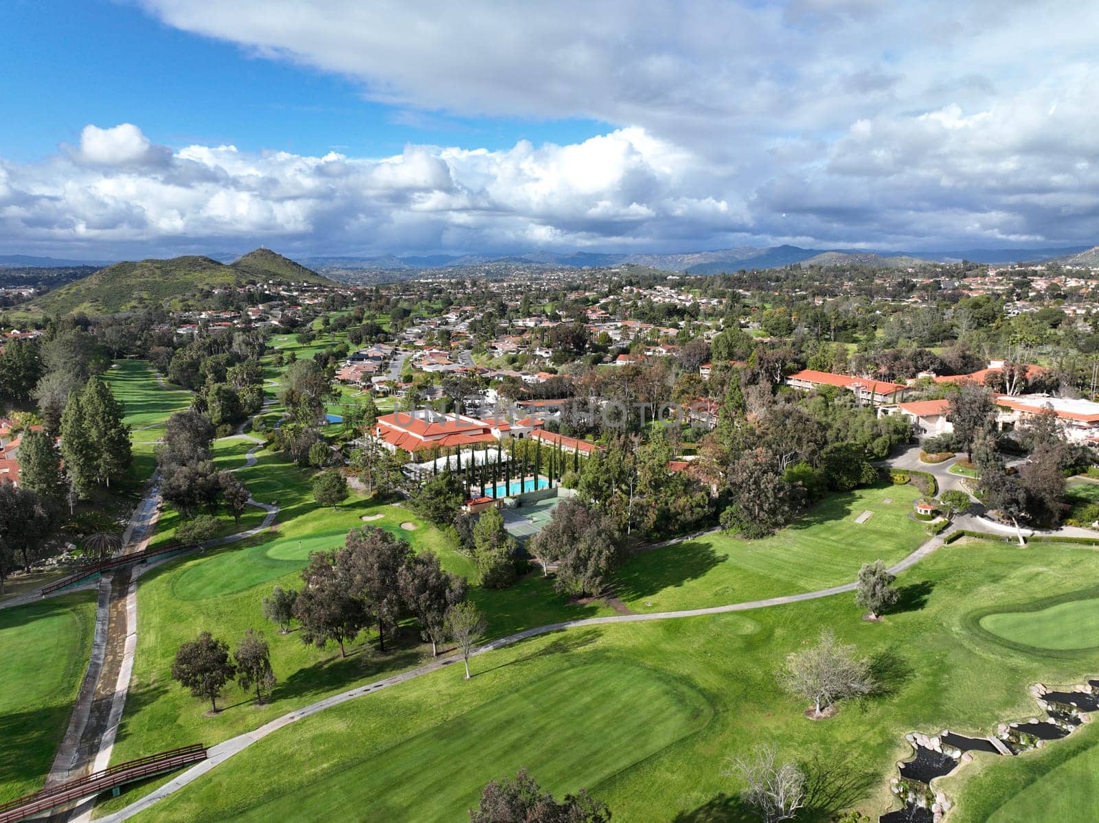 Aerial view of residential neighborhood surrounded by golf and valley during cloudy day in Rancho Bernardo by Bonandbon