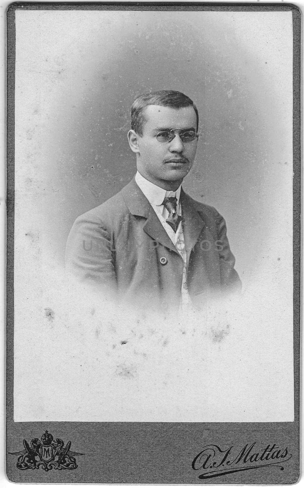 CHRUDIM, CZECHOSLOVAKIA - CIRCA 1920: Vintage cabinet card shows portrait of young man. Photo was taken in a photo studio.