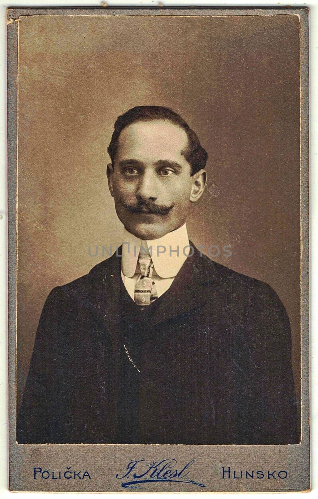 Vintage cabinet card shows portrait of the middle-aged man with moustache. Edwardian fashion. Photo was taken in a photo studio. Photo was taken in Austro-Hungarian Empire or also Austro-Hungarian Monarchy by roman_nerud