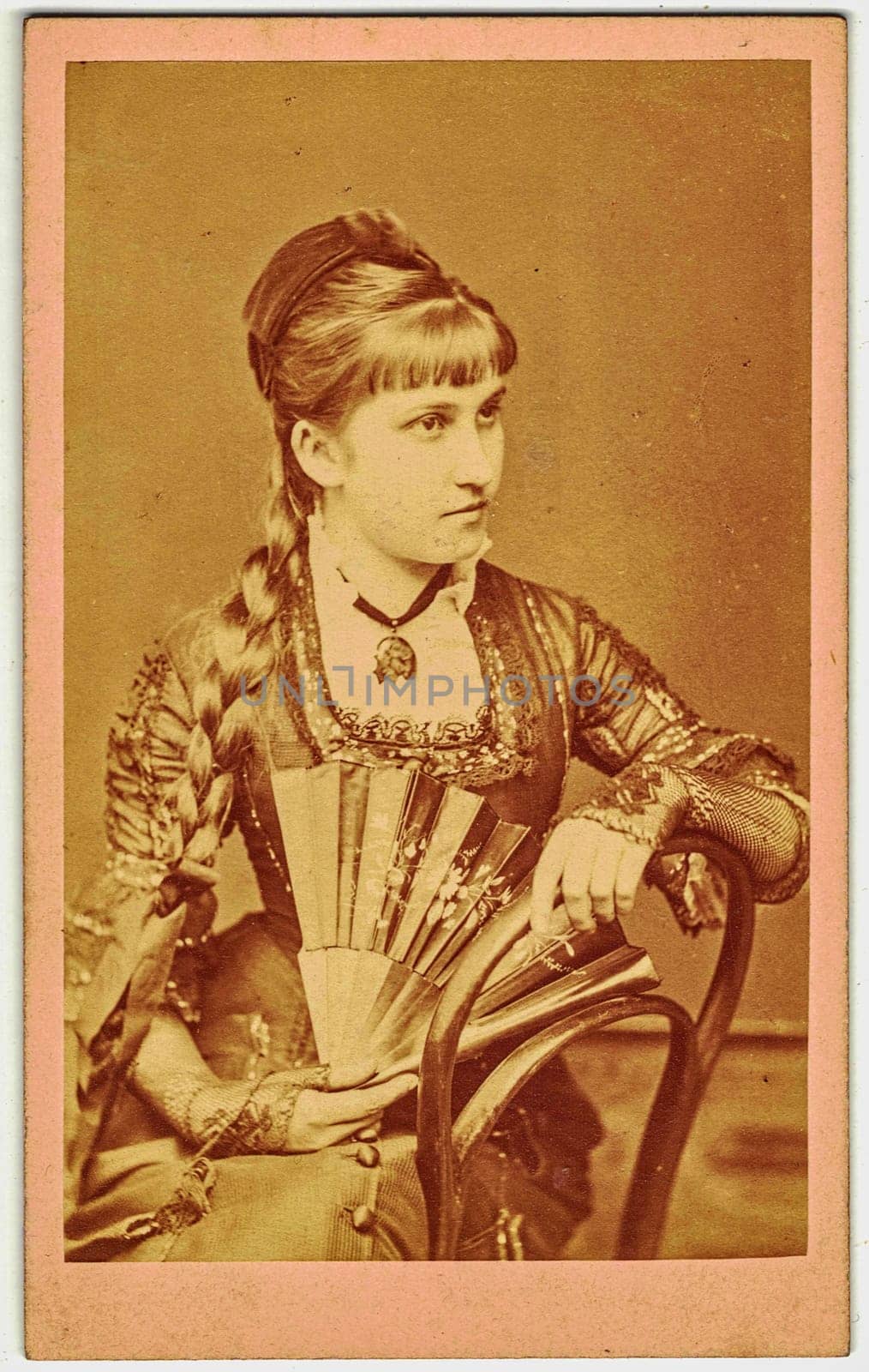 Vintage cabinet card shows portrait of the young girl 20 years old . Photo was taken in a photo studio. Edwardian hairstyle. Photo was taken in Austro-Hungarian Empire or also Austro-Hungarian Monarchy. by roman_nerud