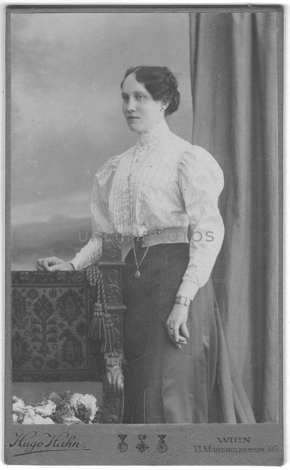 Vintage cabinet card shows portrait of the middle-aged woman. Photo was taken in a photo studio. Edwardian hairstyle. Photo was taken in Austro-Hungarian Empire or also Austro-Hungarian Monarchy. by roman_nerud