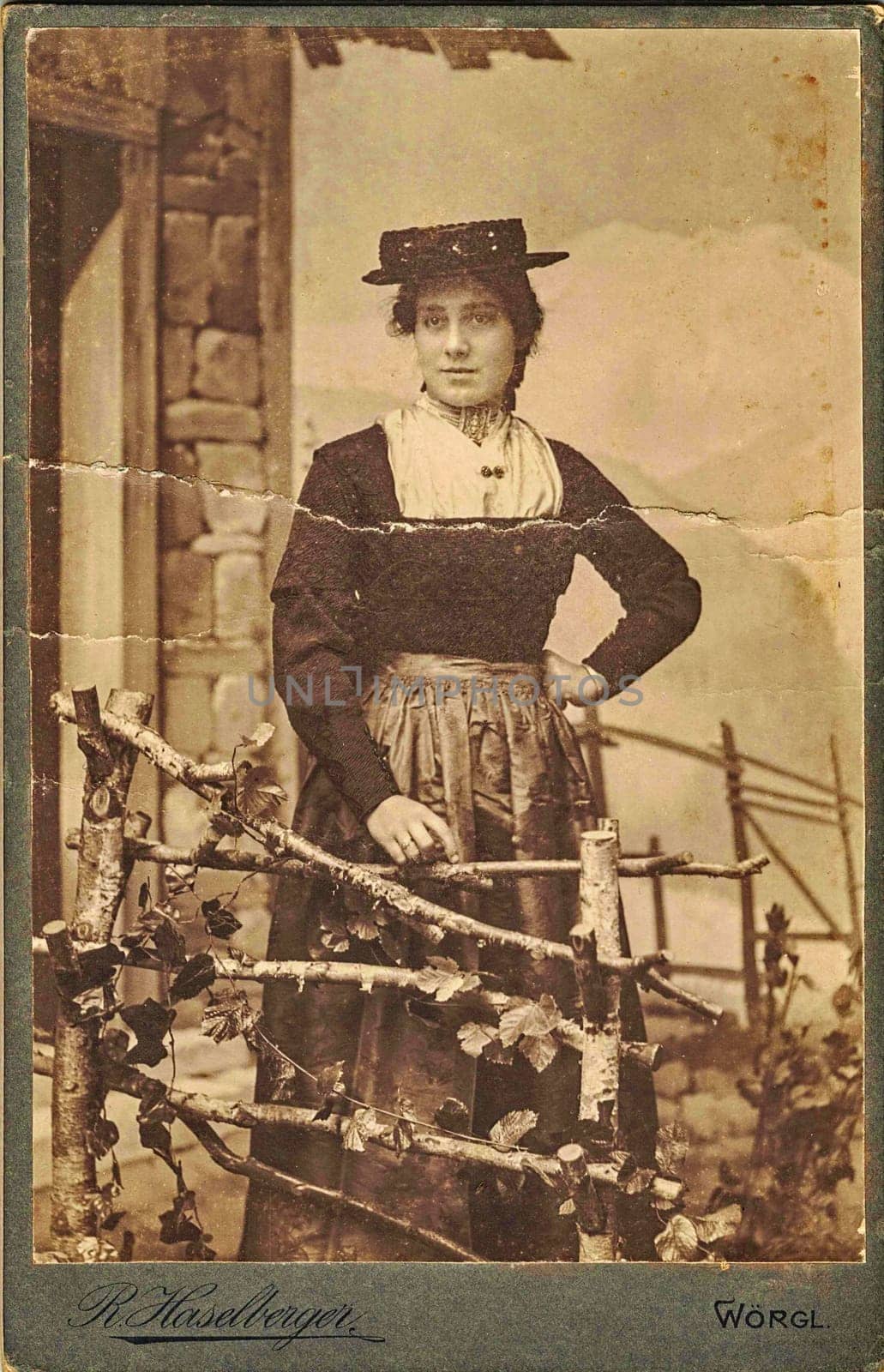 WORGL, AUSTRIA-HUNGARY - CIRCA 1900: Vintage cabinet card shows woman posing in a photo(graphic) studio. Photo was taken in Austro-Hungarian Empire or also Austro-Hungarian Monarchy by roman_nerud