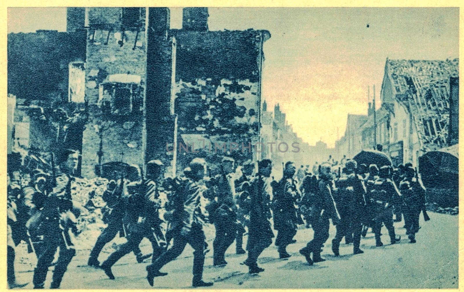 FRANCE - MAY,1940: German troops marched trhrough destroyed village in France. Nazi Germany invaded in France in 1940.