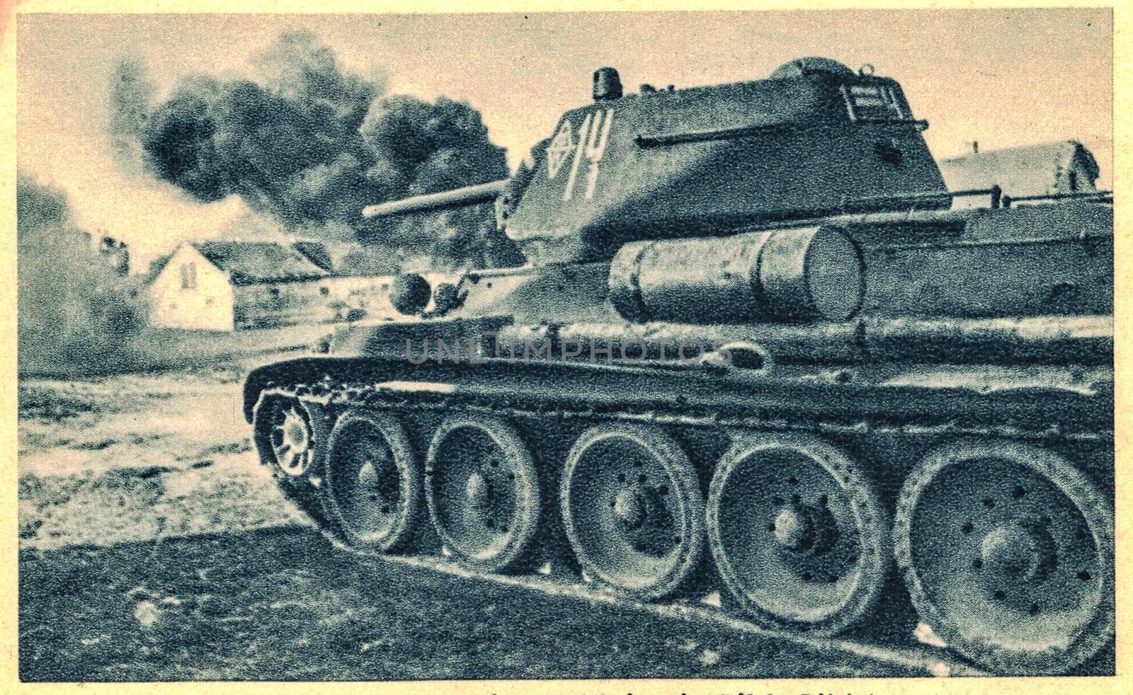 EUROPE - CIRCA 1943: The T-34 is a Soviet medium tank introduced in 1940, famously deployed during World War II against Operation Barbarossa. The T-34 destroys unknown village in Europe.