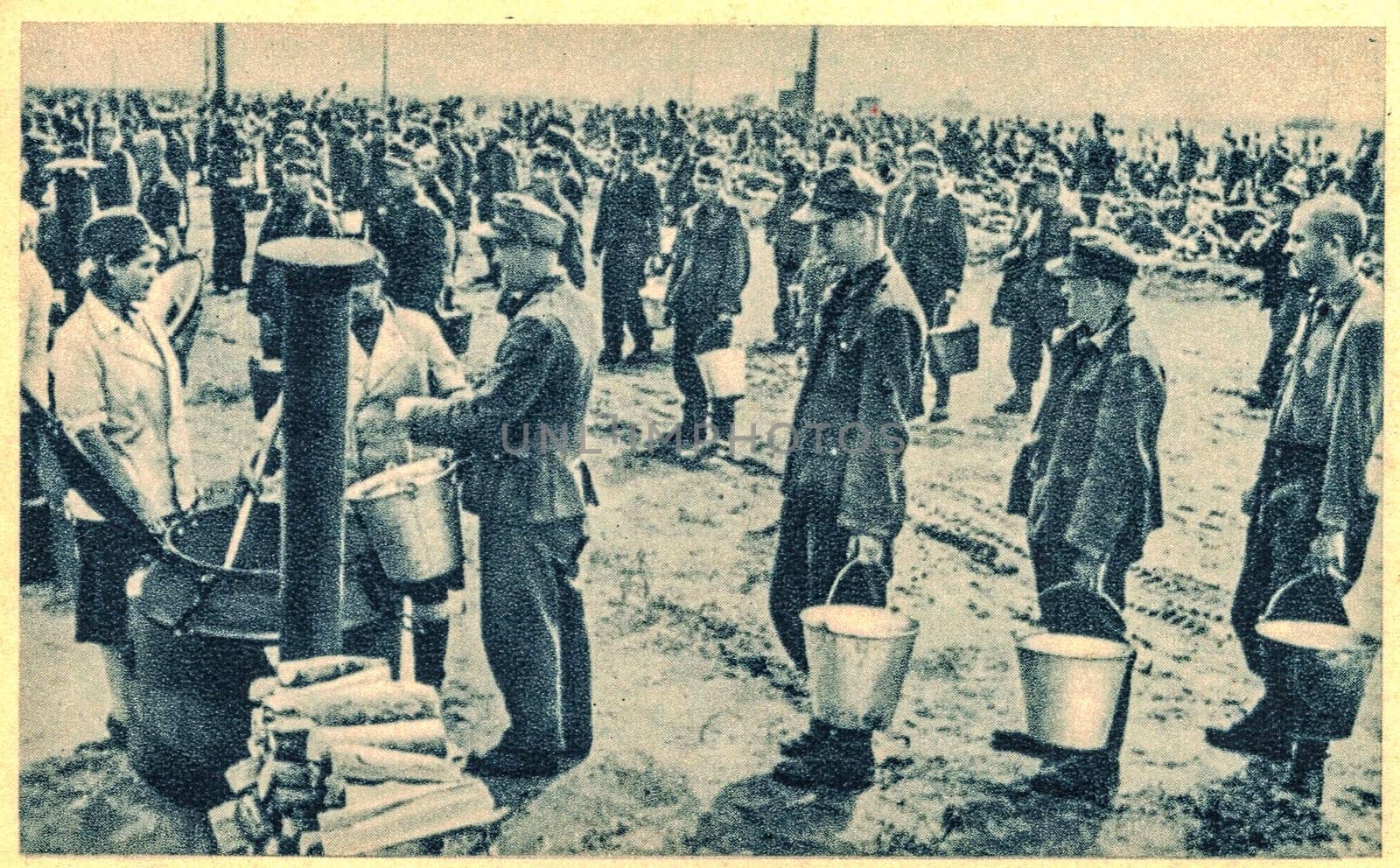 EAST EUROPE - 1944: German soldiers in POW camp. In the photo German soldiers are queuing for food, portion of soup.
