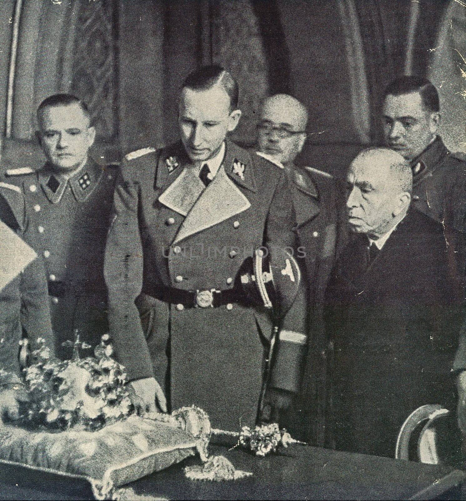 Reinhard Heydrich, Deputy Reich Protector of the Protectorate of Bohemia and Moravia, left, and Emil Hacha, State President, at the Prague Castle in Prague, Protectorate of Bohemia and Moravia. Heydrich admires crown jewels. by roman_nerud