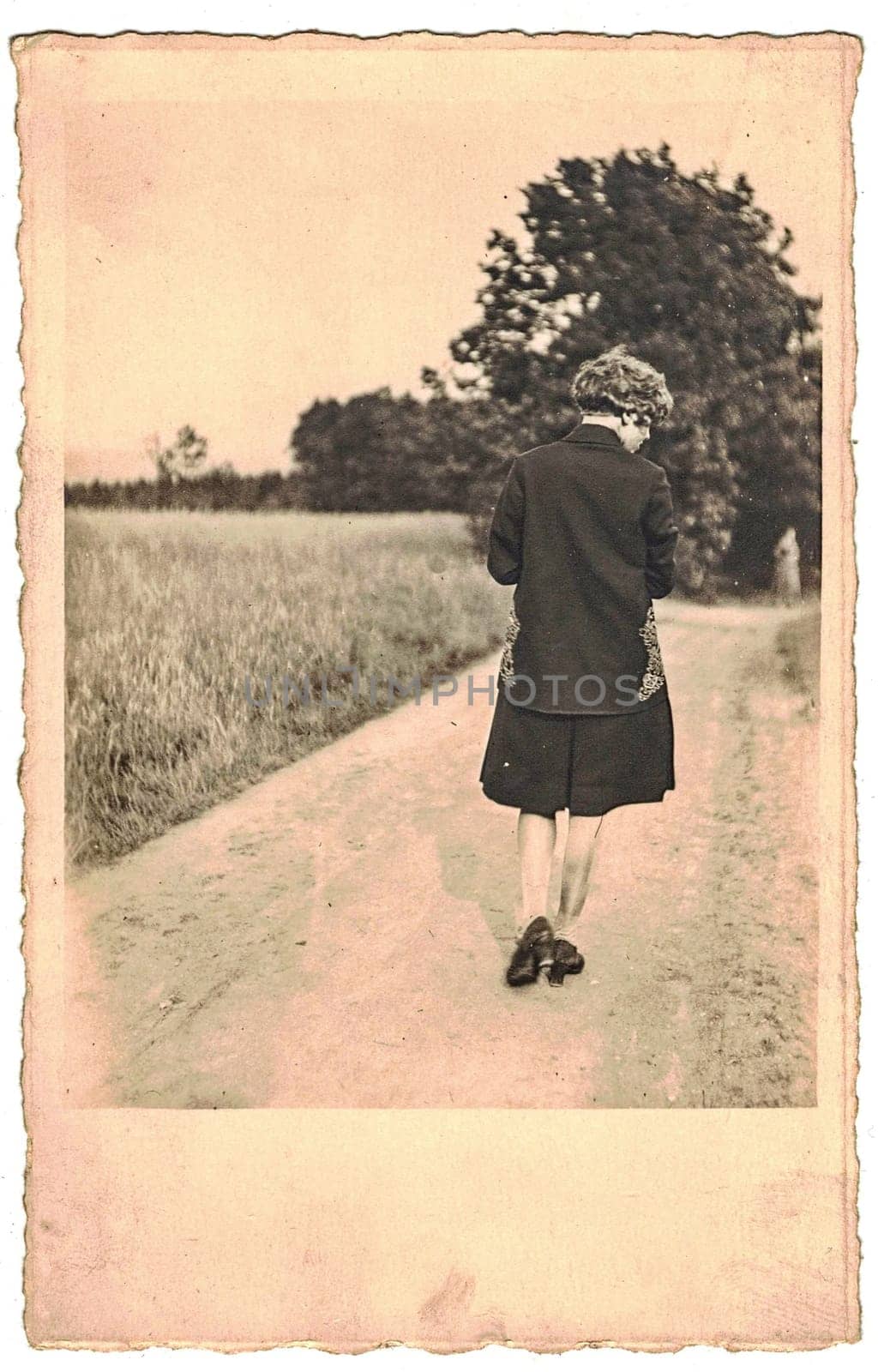Retro photo shows woman goes for a walk. Black and white photography from the golden sixties. by roman_nerud