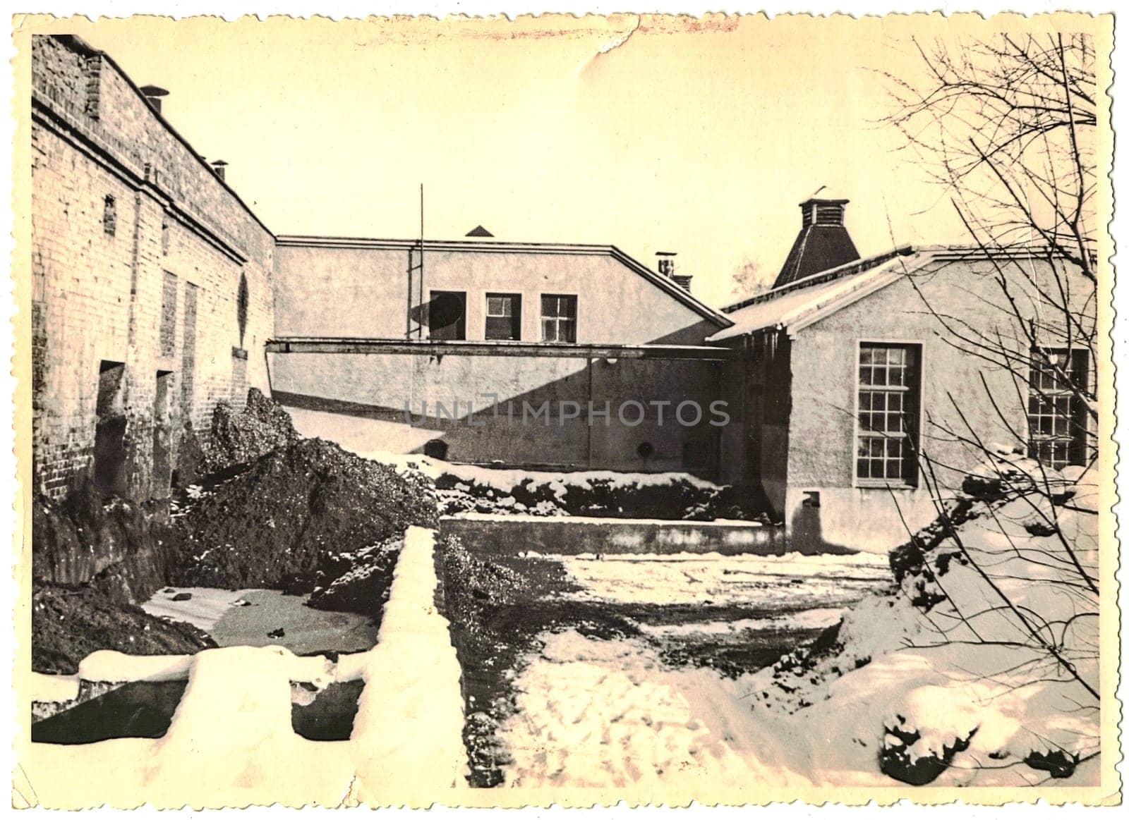 FRAUREUTH, EAST GERMANY - FEBRUARY 1965: The retro photo shows old industry zone in former East Germany. Black and white photo.