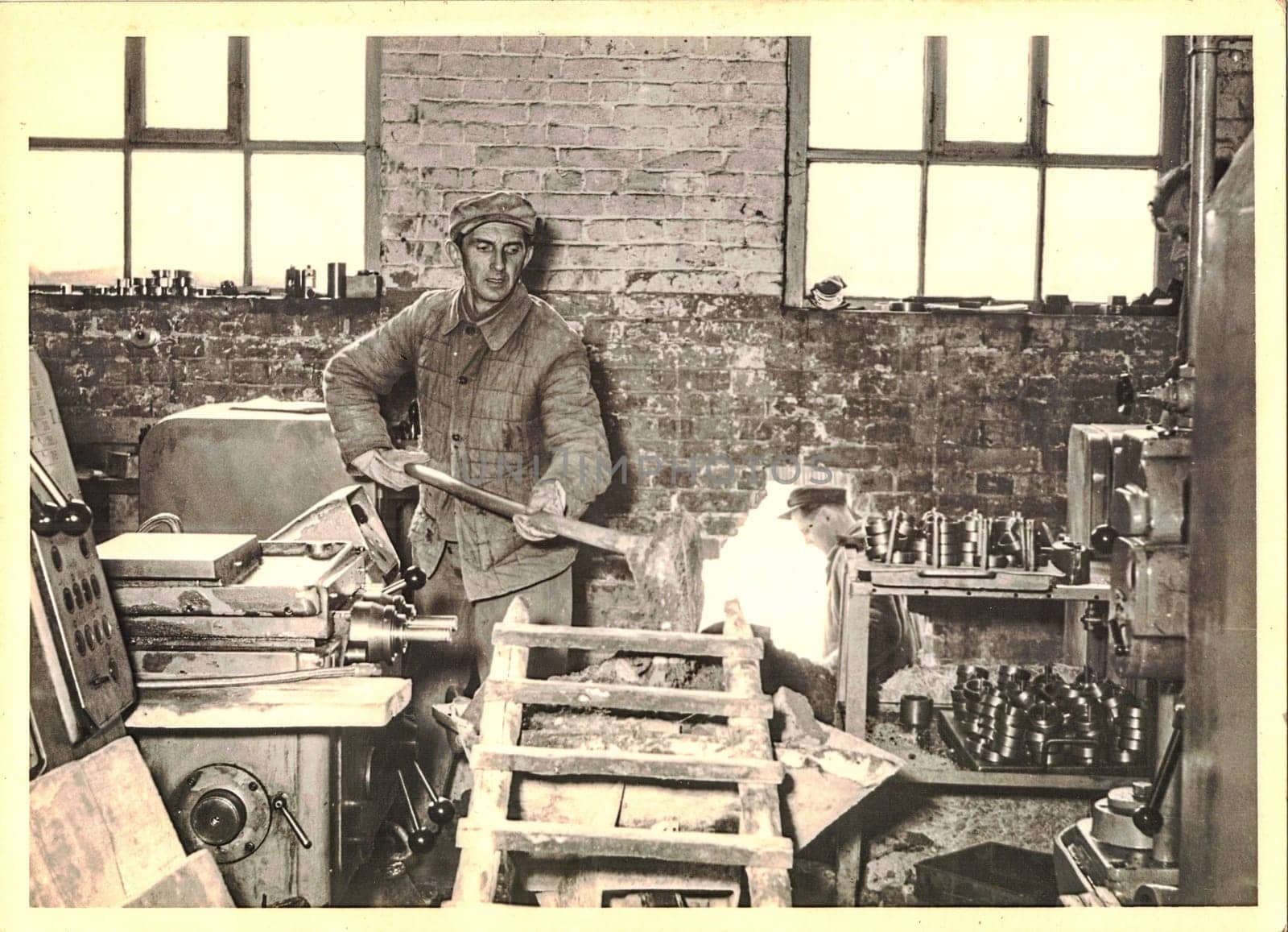 FRAUREUTH, EAST GERMANY - MARCH 3, 1965: Worker in factory. Retro photo from former East Germany.