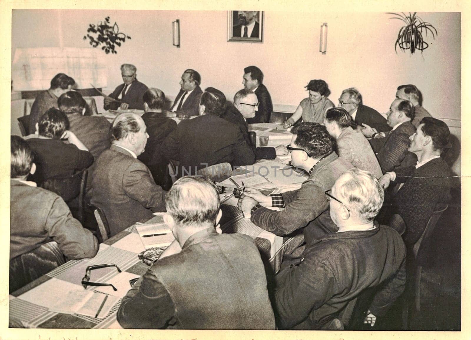 FRAUREUTH, EAST GERMANY - MAY 6, 1965: The retro photo shows company meeting in Communist bloc. Former East Germany, 1960s.