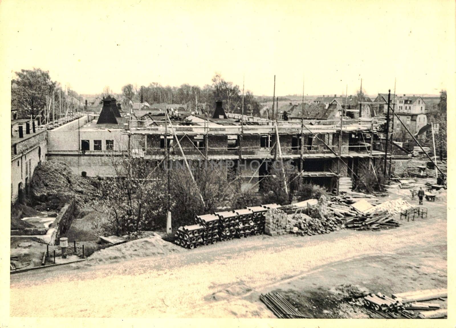 FRAUREUTH, EAST GERMANY - MAY 7, 1965: The retro photo shows construction site in Communist bloc. Former East Germany, 1960s.