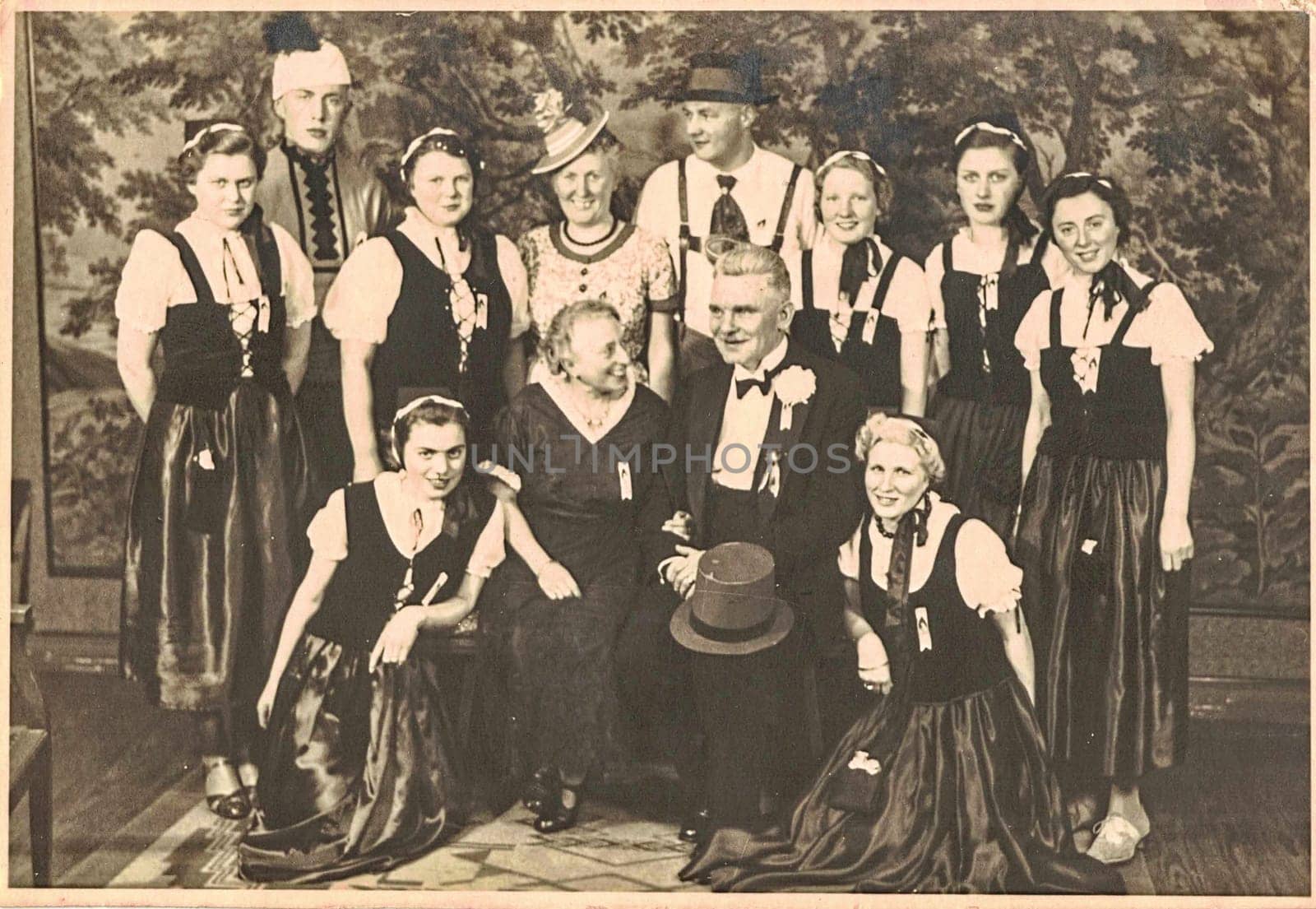 GERMANY - FEBRUARY 16, 1939: The vintage photo shows a group of people celebrating social event. Carnival, masquerade ball, dancing party...