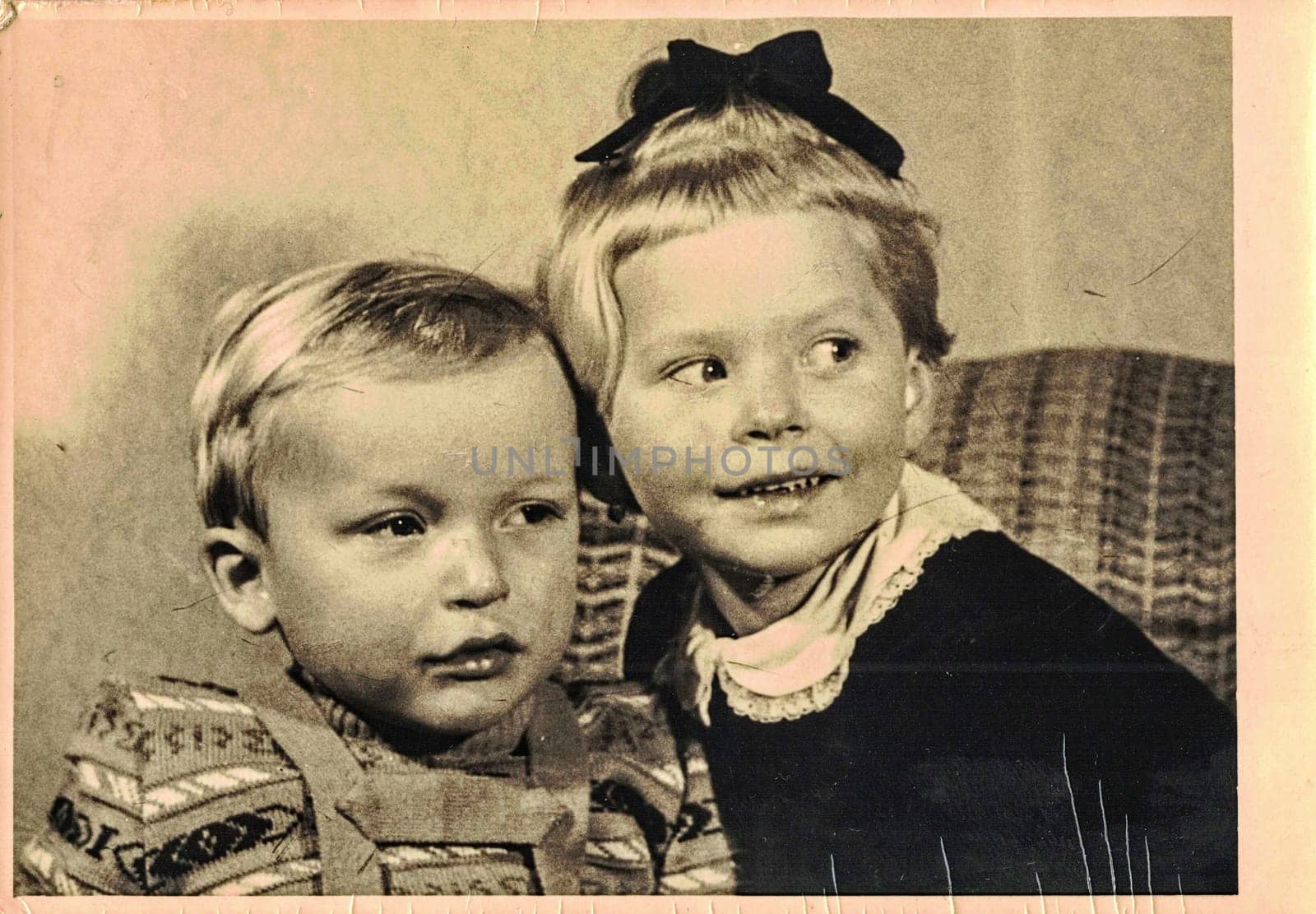 Vintage photo shows two small children - siblings - brother and sister. About two and four years old. by roman_nerud