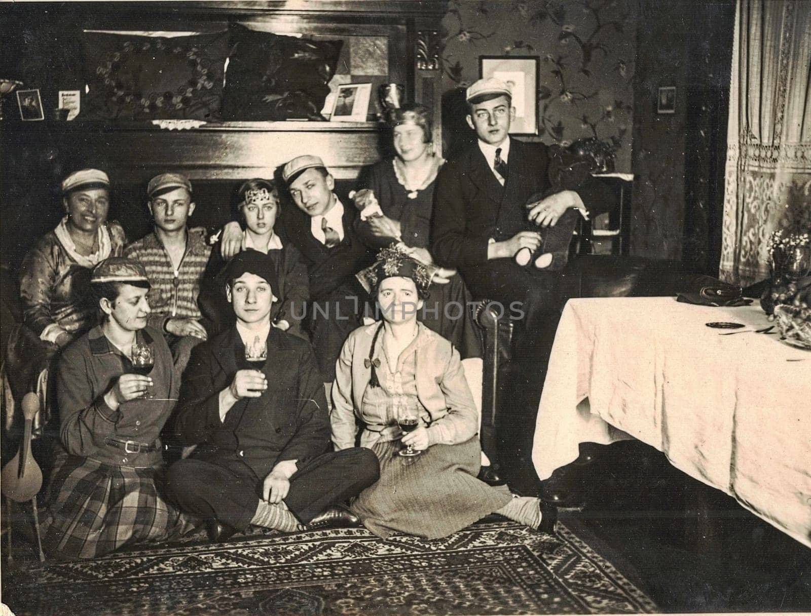 The retro photo shows a group of happy people celebrate a social event - birthday, party...Golden the thirties before the war. by roman_nerud