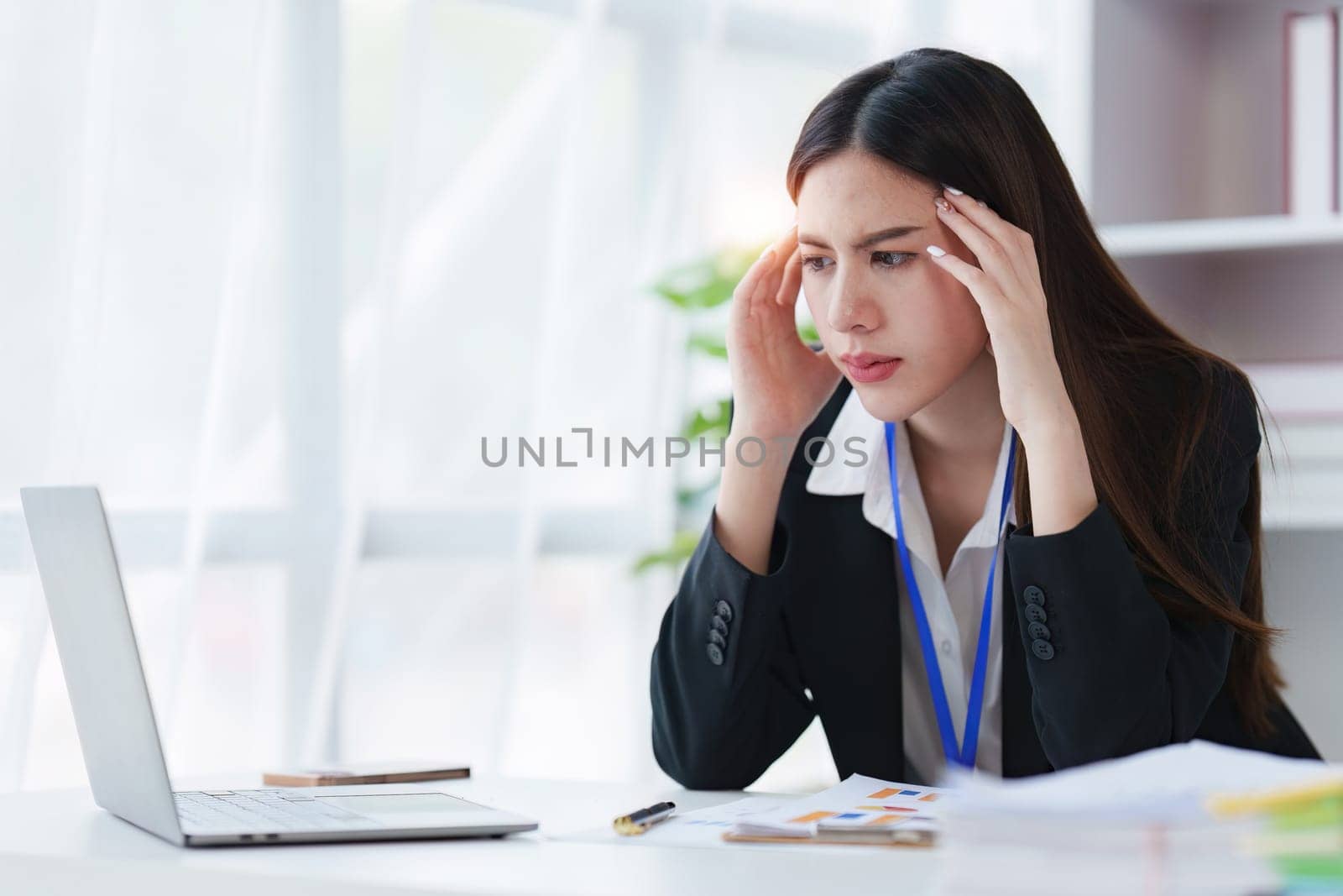 Businessperson have anxiety and stress and pressure with many financial document paperwork on desk, deadline, upset, depressed concept by itchaznong