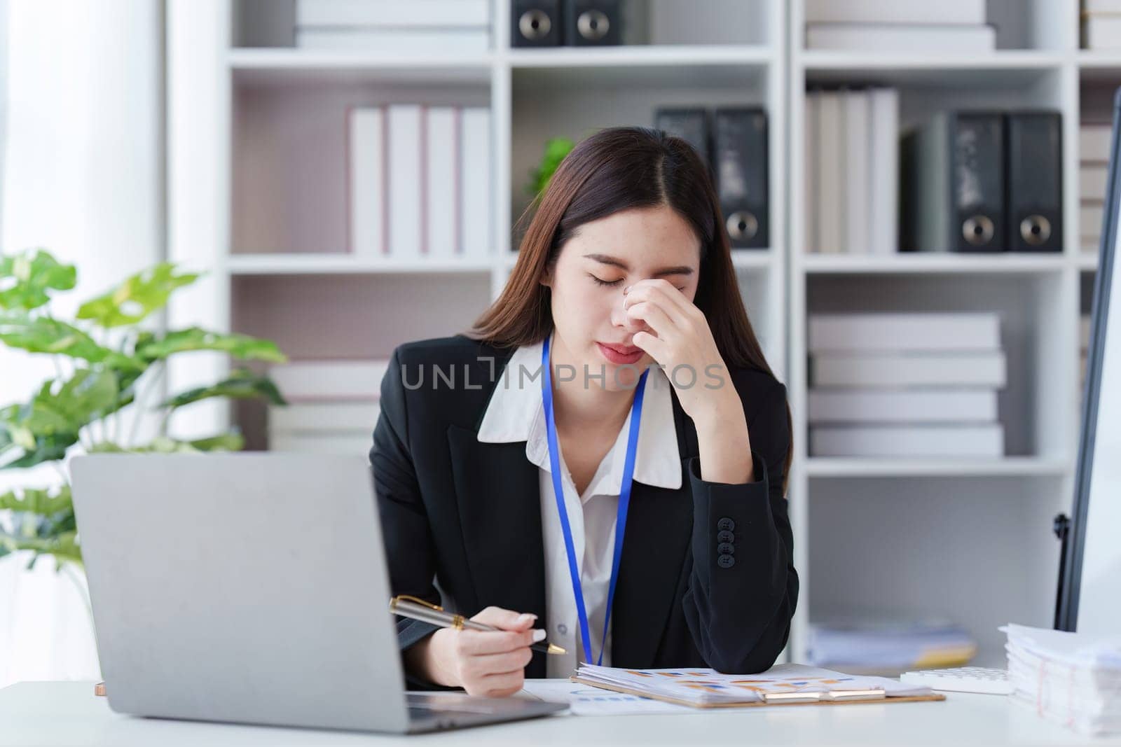 Businessperson have anxiety and stress and pressure with many financial document paperwork on desk, deadline, upset, depressed concept by itchaznong