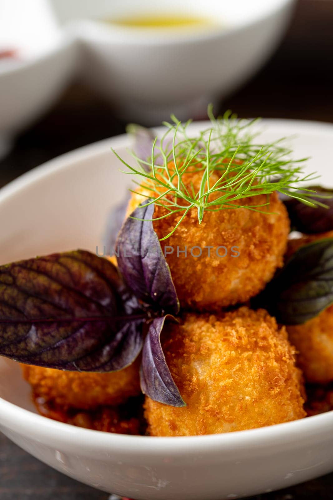 Homemade Fried Sicilian Arancini stuffed with meat, with tomato sauce