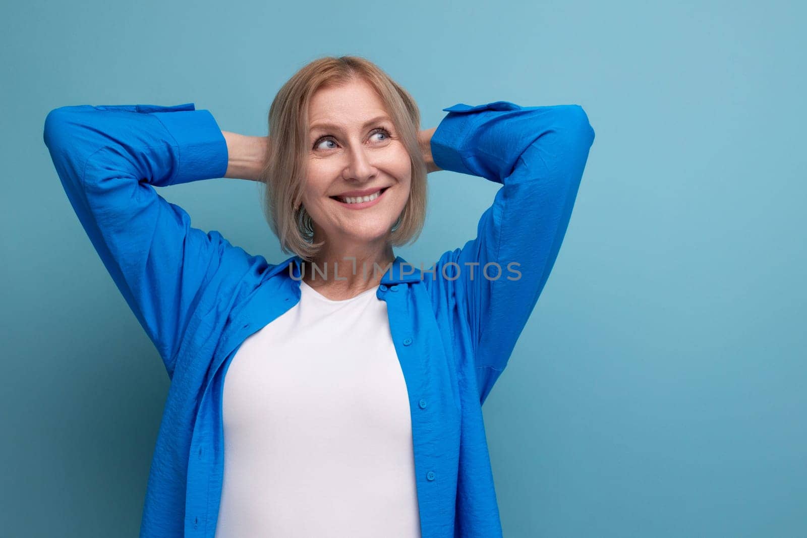 dreamy blond mature woman with bob haircut on studio background by TRMK